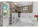 Classic bathroom with pedestal sink, bathtub, and black and white tile floor at 1332 3Rd W Ave, Bradenton, FL 34205