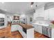 Bright kitchen with white cabinets, island, stainless steel appliances, and hardwood floors at 1332 3Rd W Ave, Bradenton, FL 34205