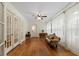 Sunroom with hardwood floors, white walls, and antique couch at 1332 3Rd W Ave, Bradenton, FL 34205