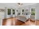 Bright bedroom with hardwood floors, white furniture, and ceiling fan at 1332 3Rd W Ave, Bradenton, FL 34205