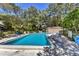 Inviting community pool with lounge chairs and a spacious deck at 6935 Arbor Oaks Cir, Bradenton, FL 34209