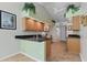 Kitchen boasts granite countertops, light wood cabinets and breakfast bar at 6935 Arbor Oaks Cir, Bradenton, FL 34209