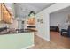 Modern kitchen with granite counters, light wood cabinets and view of living room at 6935 Arbor Oaks Cir, Bradenton, FL 34209