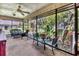 Relaxing screened porch with seating area overlooking backyard at 6935 Arbor Oaks Cir, Bradenton, FL 34209