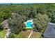 Community pool surrounded by trees and green space at 6935 Arbor Oaks Cir, Bradenton, FL 34209