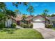 Brick home with a two-car garage and mature landscaping at 6935 Arbor Oaks Cir, Bradenton, FL 34209