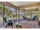 Spacious screened porch, wicker furniture, view of backyard at 6935 Arbor Oaks Cir, Bradenton, FL 34209