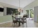 Charming breakfast nook with stained glass light and view of backyard at 6935 Arbor Oaks Cir, Bradenton, FL 34209