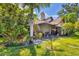 Private backyard with lush landscaping and screened patio at 6935 Arbor Oaks Cir, Bradenton, FL 34209
