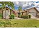 Single-Gathering home with a red door and lush landscaping at 6935 Arbor Oaks Cir, Bradenton, FL 34209