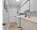 Bright laundry room with washer, dryer, cabinets, and sink at 6935 Arbor Oaks Cir, Bradenton, FL 34209
