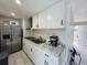 Modern kitchen with stainless steel appliances and white cabinets at 303 48Th W St, Bradenton, FL 34209
