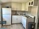 Modern kitchen featuring white cabinets and a corner sink at 303 48Th W St, Bradenton, FL 34209