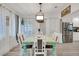 Charming dining room featuring a rustic turquoise table and white chairs, perfect for Gathering meals at 303 48Th W St, Bradenton, FL 34209