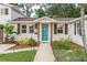 Front door view of a charming home with landscaped walkway and garden at 303 48Th W St, Bradenton, FL 34209