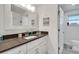 Bathroom with a vanity, dark countertop, and white cabinets at 303 48Th W St, Bradenton, FL 34209