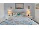 Cozy bedroom with a queen-size bed, featuring coastal-themed bedding and nightstands at 303 48Th W St, Bradenton, FL 34209