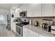 Modern kitchen with white cabinets and stainless steel appliances at 303 48Th W St, Bradenton, FL 34209