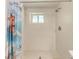 Clean shower with tile surround and a window for natural light at 303 48Th W St, Bradenton, FL 34209
