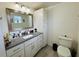 Bathroom with a vanity, toilet, and a large mirror at 303 48Th W St, Bradenton, FL 34209
