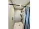 Stand up shower with gray tile and shower curtain at 303 48Th W St, Bradenton, FL 34209