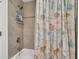 Clean bathroom with a bathtub and beach-themed shower curtain at 303 48Th W St, Bradenton, FL 34209