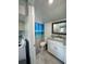 Updated bathroom with white vanity and a beach-themed shower curtain at 303 48Th W St, Bradenton, FL 34209