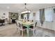 Charming dining area with teal table and white chairs at 303 48Th W St, Bradenton, FL 34209