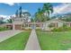 Front view of a charming two-story home with a landscaped yard at 303 48Th W St, Bradenton, FL 34209