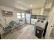Cozy kitchen features white cabinets, new appliances, and vinyl plank flooring at 303 48Th W St, Bradenton, FL 34209
