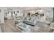 Open concept living and kitchen area with gray sectional sofa at 303 48Th W St, Bradenton, FL 34209