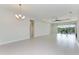 Spacious living room featuring tile floors and pool view at 12734 Rainwashed Loop, Parrish, FL 34219