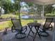 This home features a screened patio with chairs, a table, and a view of a pond at 3653 Bonaventure Ct, Sarasota, FL 34243