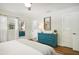 Bright bedroom with teal dresser, mirror, and ample closet space at 500 Pameto Rd, Nokomis, FL 34275