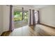 Bedroom with sliding glass doors opening to a screened porch and pond view at 3653 Bonaventure Ct, Sarasota, FL 34243