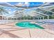 Inviting community pool with covered patio and spa at 3653 Bonaventure Ct, Sarasota, FL 34243