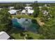Aerial view showcasing a community pond and surrounding homes at 3653 Bonaventure Ct, Sarasota, FL 34243