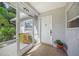 Front entry with screen door, white door and potted plant at 3653 Bonaventure Ct, Sarasota, FL 34243