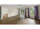Spacious bedroom with wood-look floors and access to another room at 3653 Bonaventure Ct, Sarasota, FL 34243