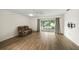 Living room features a recliner, sliding doors and wood floors at 3653 Bonaventure Ct, Sarasota, FL 34243