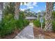 Brick walkway leading to community park, lined with lush greenery at 3653 Bonaventure Ct, Sarasota, FL 34243