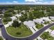 Bird's-eye view of a neighborhood with houses, trees, and a pond at 3653 Bonaventure Ct, Sarasota, FL 34243