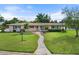 Single story home with landscaped lawn and a paved walkway at 3072 Meyer Dr, Sarasota, FL 34239