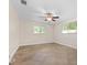 Bright bedroom with tile floors, ceiling fan, and dual windows at 3072 Meyer Dr, Sarasota, FL 34239