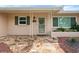 Inviting front entry with a stone patio and lush landscaping at 3072 Meyer Dr, Sarasota, FL 34239