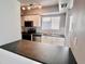 Modern kitchen featuring updated white cabinets, stainless steel appliances, and a breakfast bar at 1111 Longfellow Rd # 1111, Sarasota, FL 34243