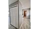 Clean hallway with tile flooring and built-in storage at 1111 Longfellow Rd # 1111, Sarasota, FL 34243