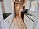 Modern kitchen with white cabinets, dark countertops, and tile flooring at 1111 Longfellow Rd # 1111, Sarasota, FL 34243
