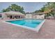 Community pool with lounge chairs and patio area at 1111 Longfellow Rd # 1111, Sarasota, FL 34243