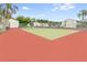 Community tennis court with red and green surface at 1111 Longfellow Rd # 1111, Sarasota, FL 34243